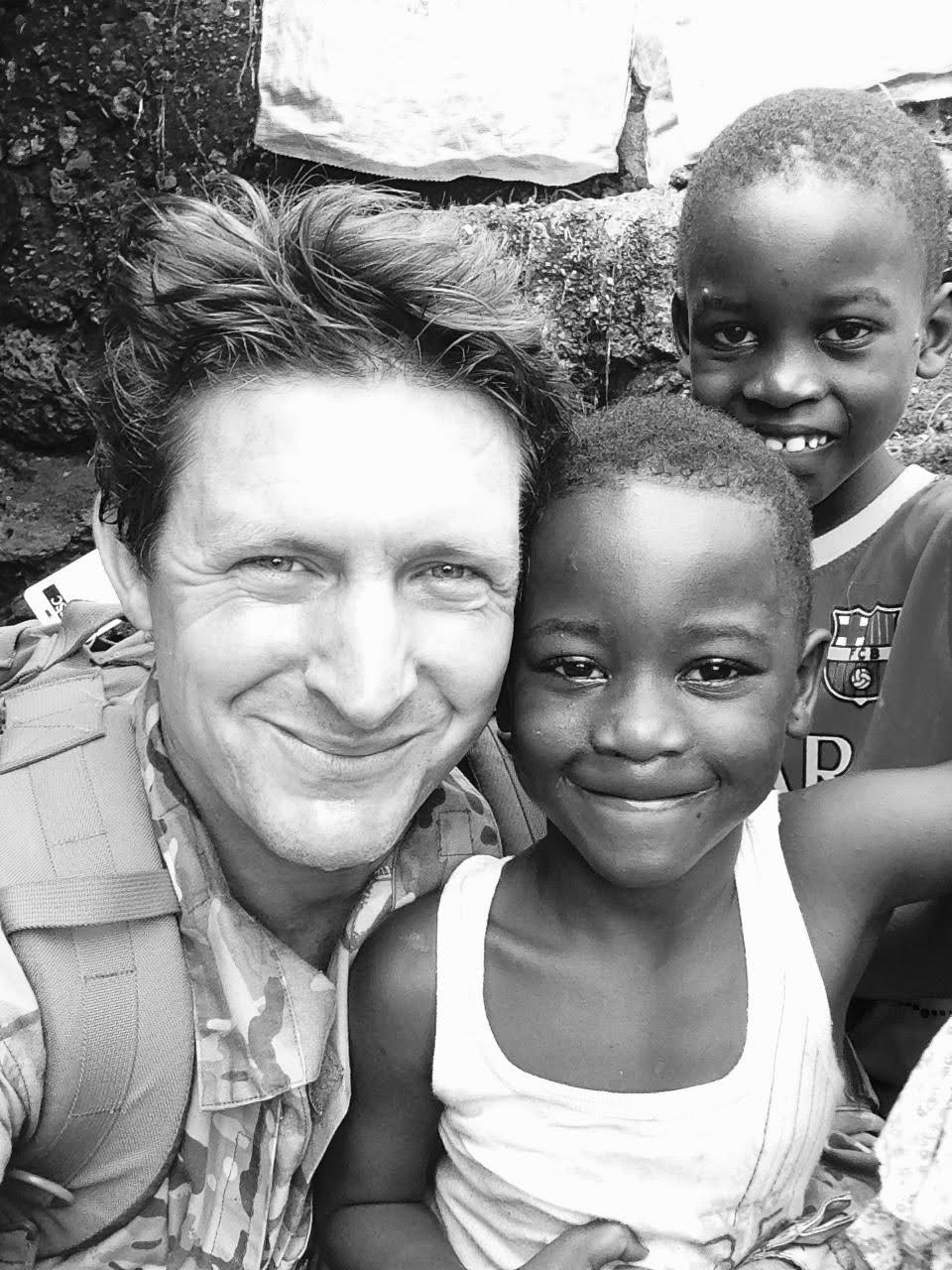 Maj Gen (Retd) Charlie Herbert with children in Sierra Leone