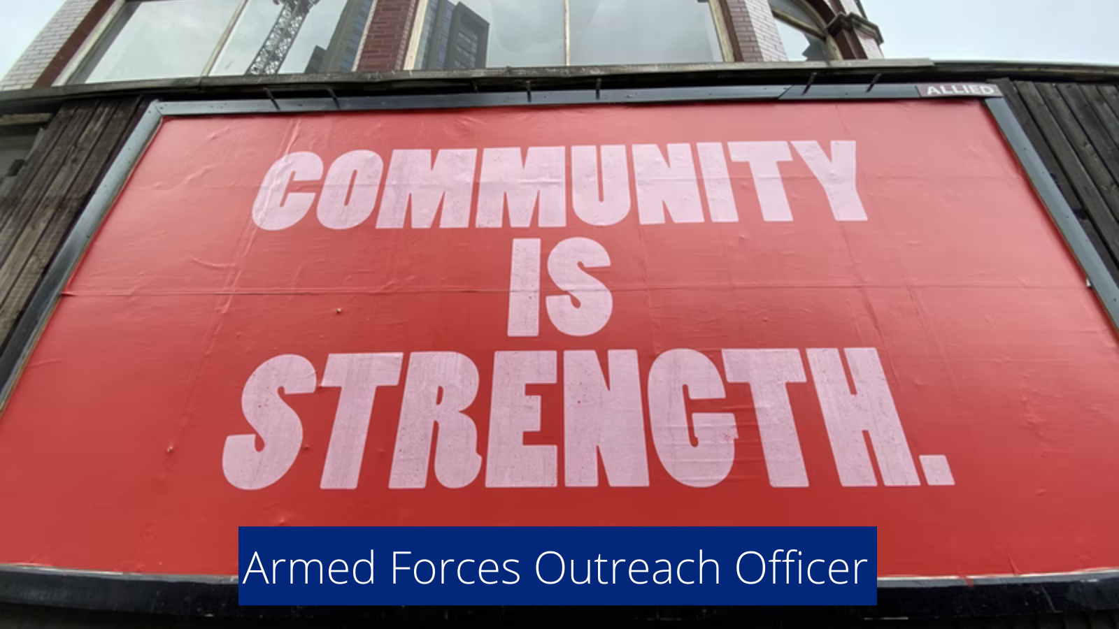 Large billboard sign that says community is strength